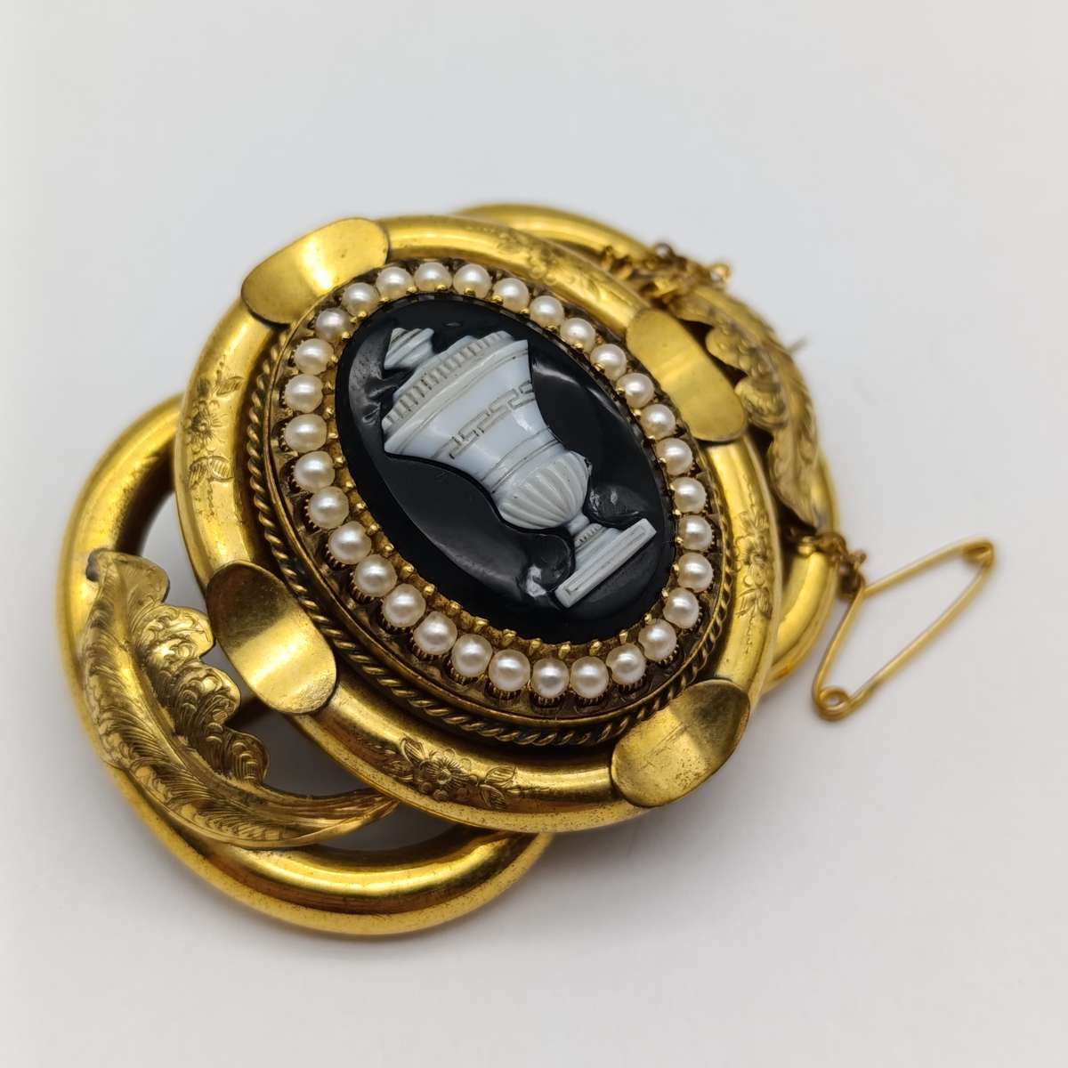 Antique low grade gold  mourning brooch with hair locket on back and safety chain