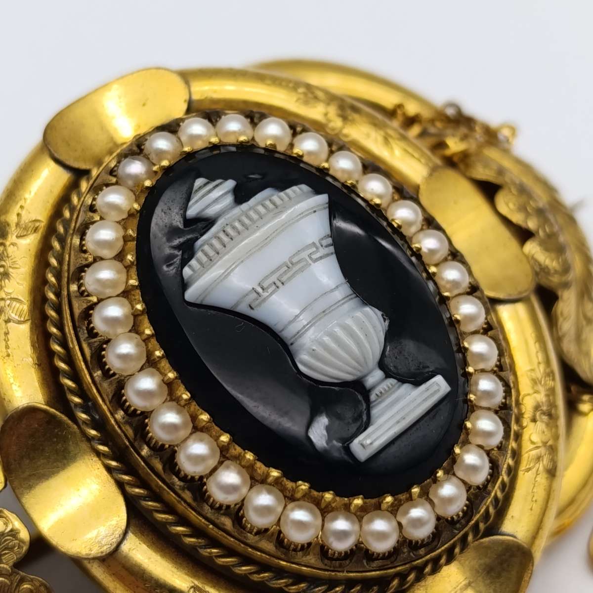 Antique low grade gold  mourning brooch with hair locket on back and safety chain