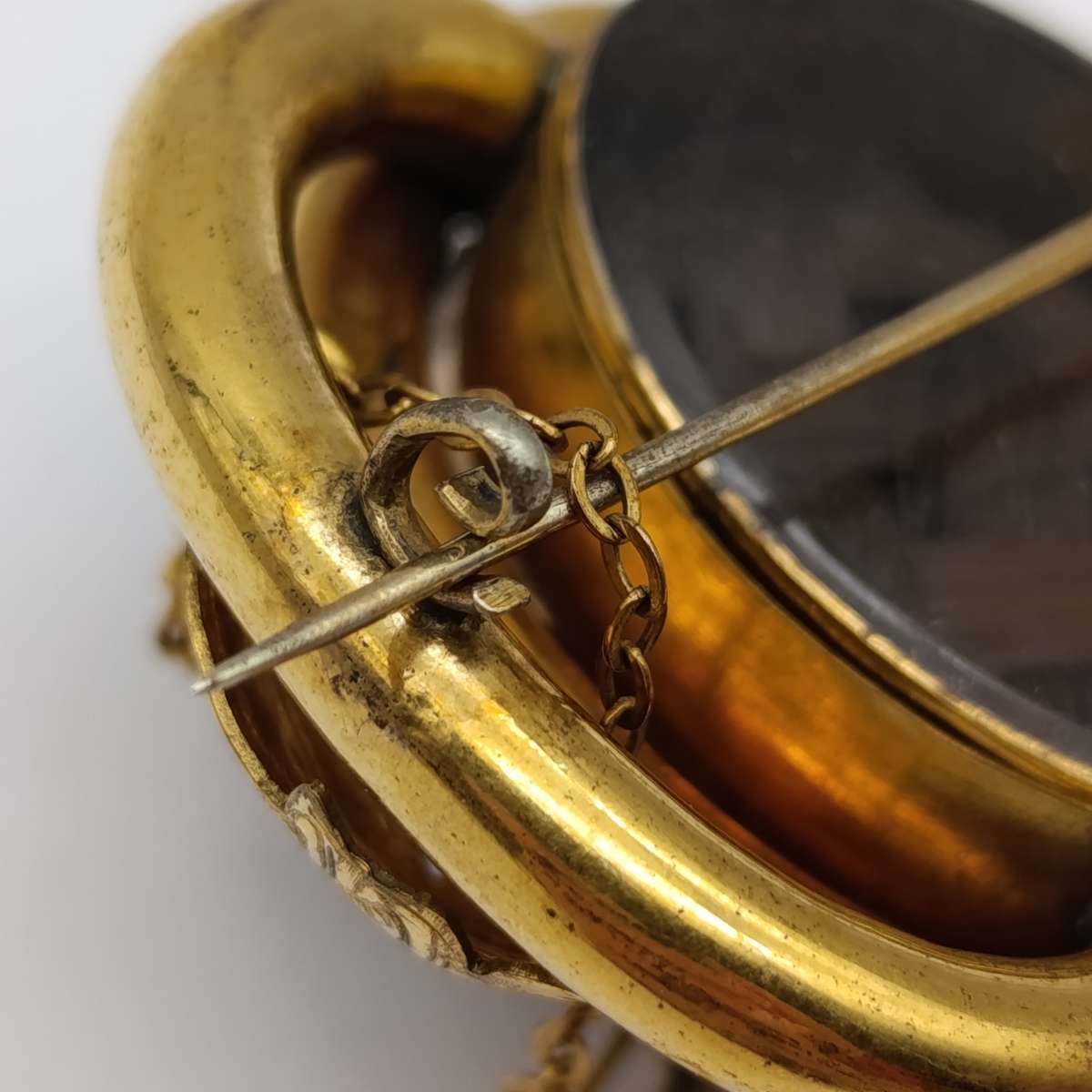 Antique low grade gold  mourning brooch with hair locket on back and safety chain