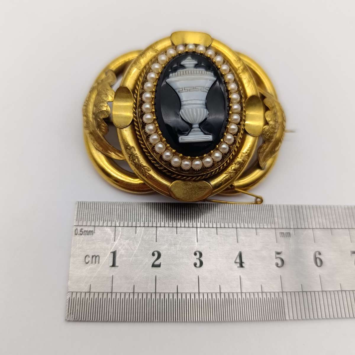 Antique low grade gold  mourning brooch with hair locket on back and safety chain