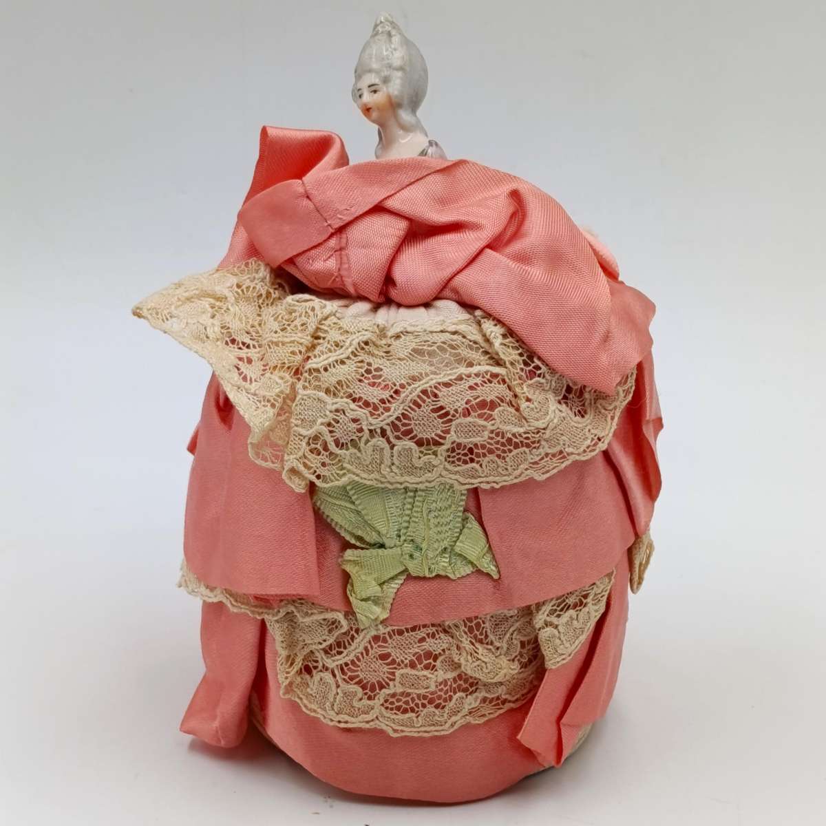Antique porcelain doll needle cushion