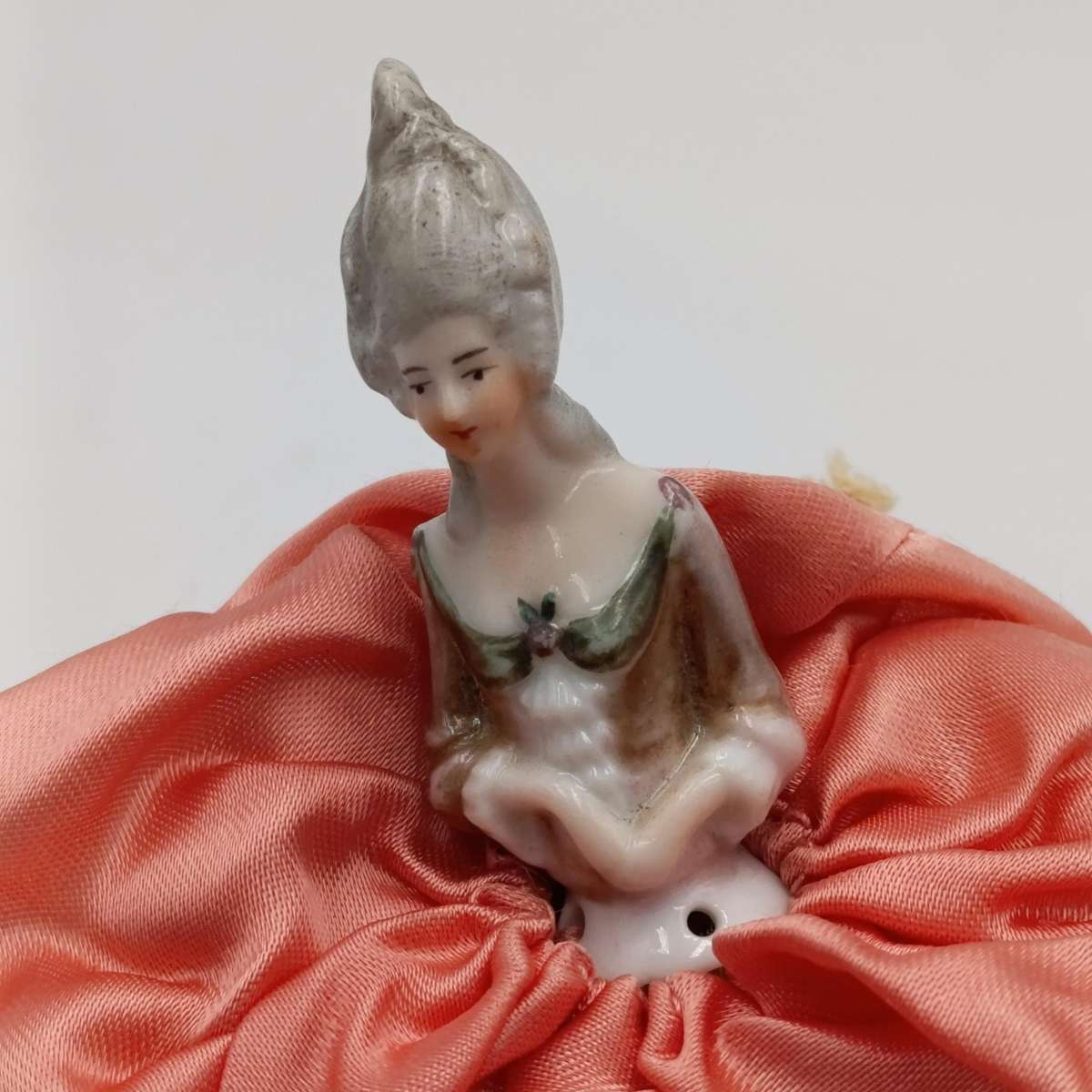 Antique porcelain doll needle cushion