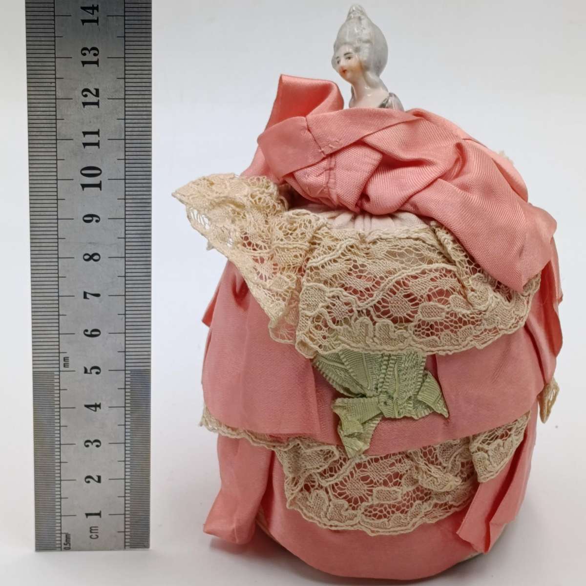 Antique porcelain doll needle cushion