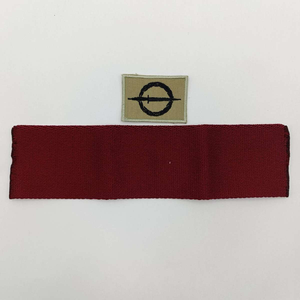 SANDF Special Forces Operator cloth badge with piece of Maroon stable belt material