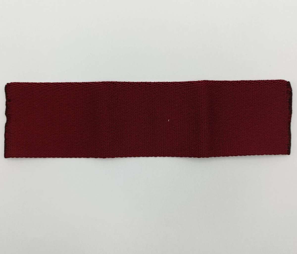 SANDF Special Forces Operator cloth badge with piece of Maroon stable belt material