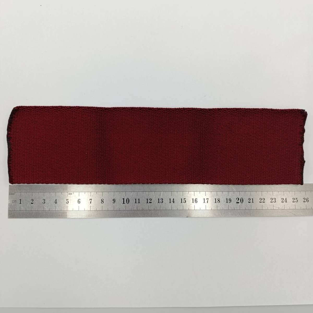 SANDF Special Forces Operator cloth badge with piece of Maroon stable belt material