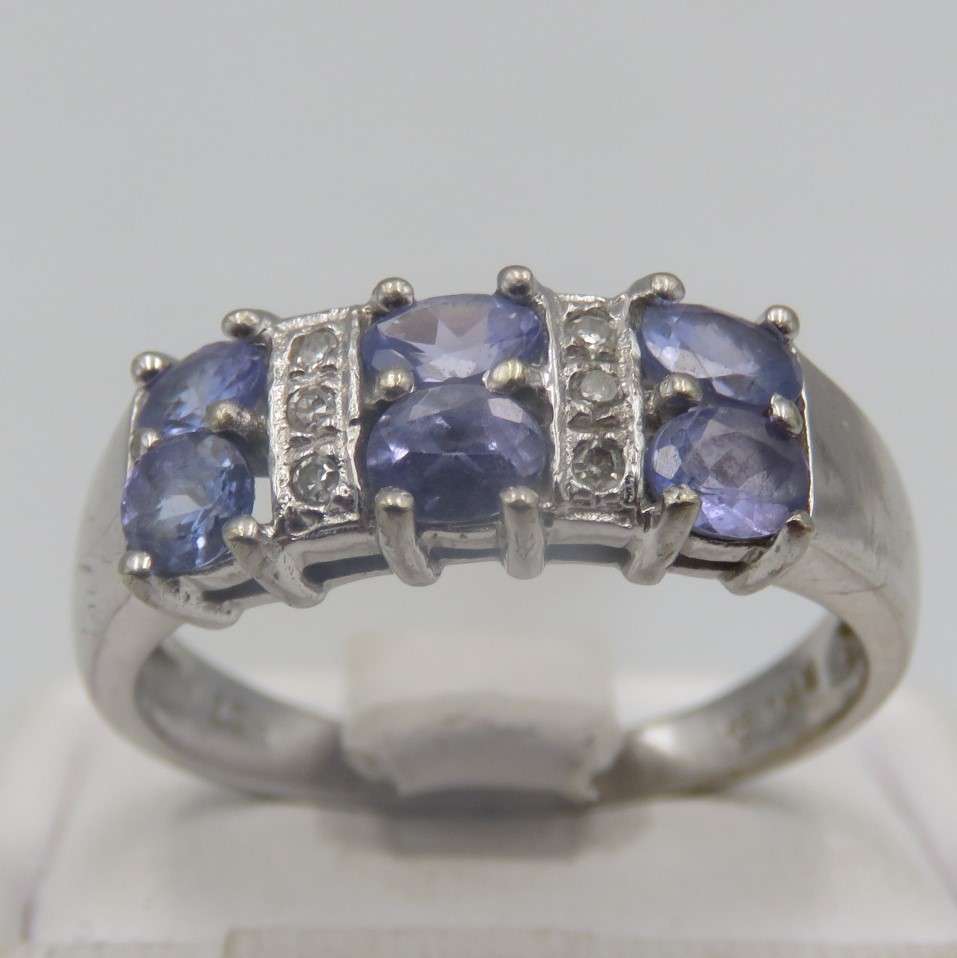 9kt white gold ring with 6 small diamonds and 6 iolites. Weight 3.5g , Size O