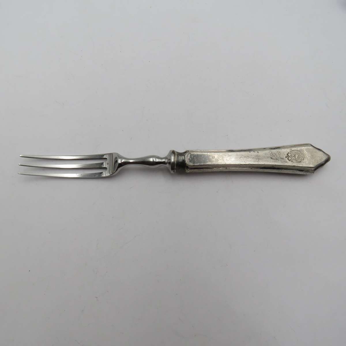 Antique pickle fork with ZAR Transvaal coat of arms on handle.