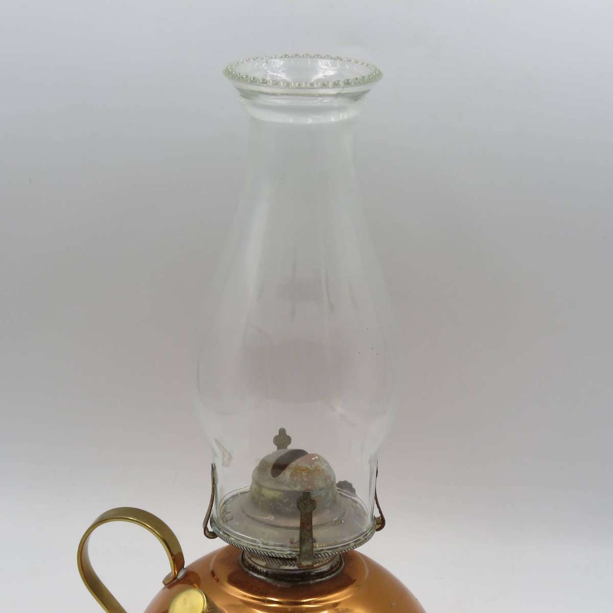 Vintage copper oil lantern with brass handle and glass chimney