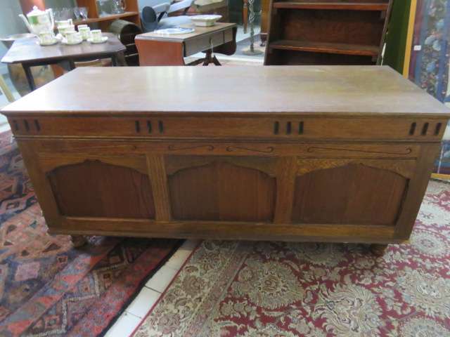 Continental oak chest with carved detail.