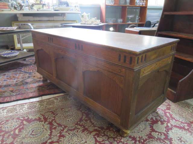 Continental oak chest with carved detail.