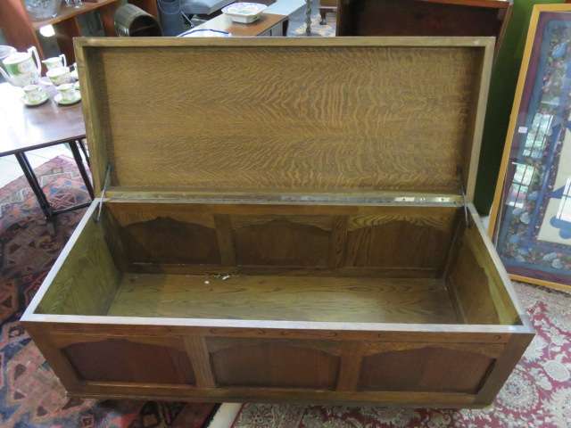 Continental oak chest with carved detail.