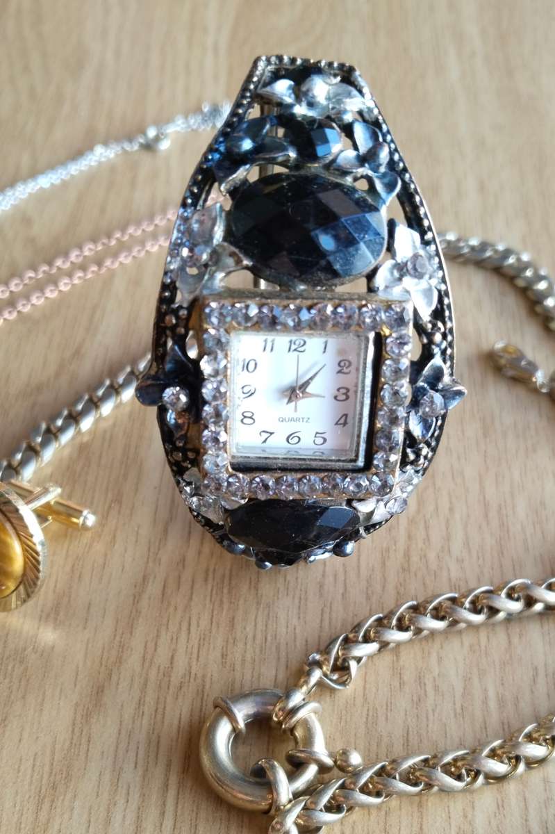 Collection of charm bracelets, necklace and watch.