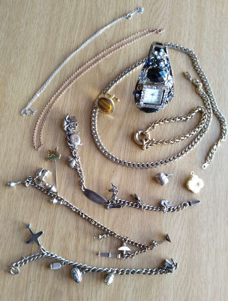 Collection of charm bracelets, necklace and watch.