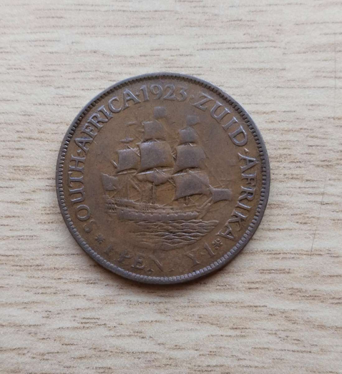 Error South Africa 1923 Penny. Faint letters.