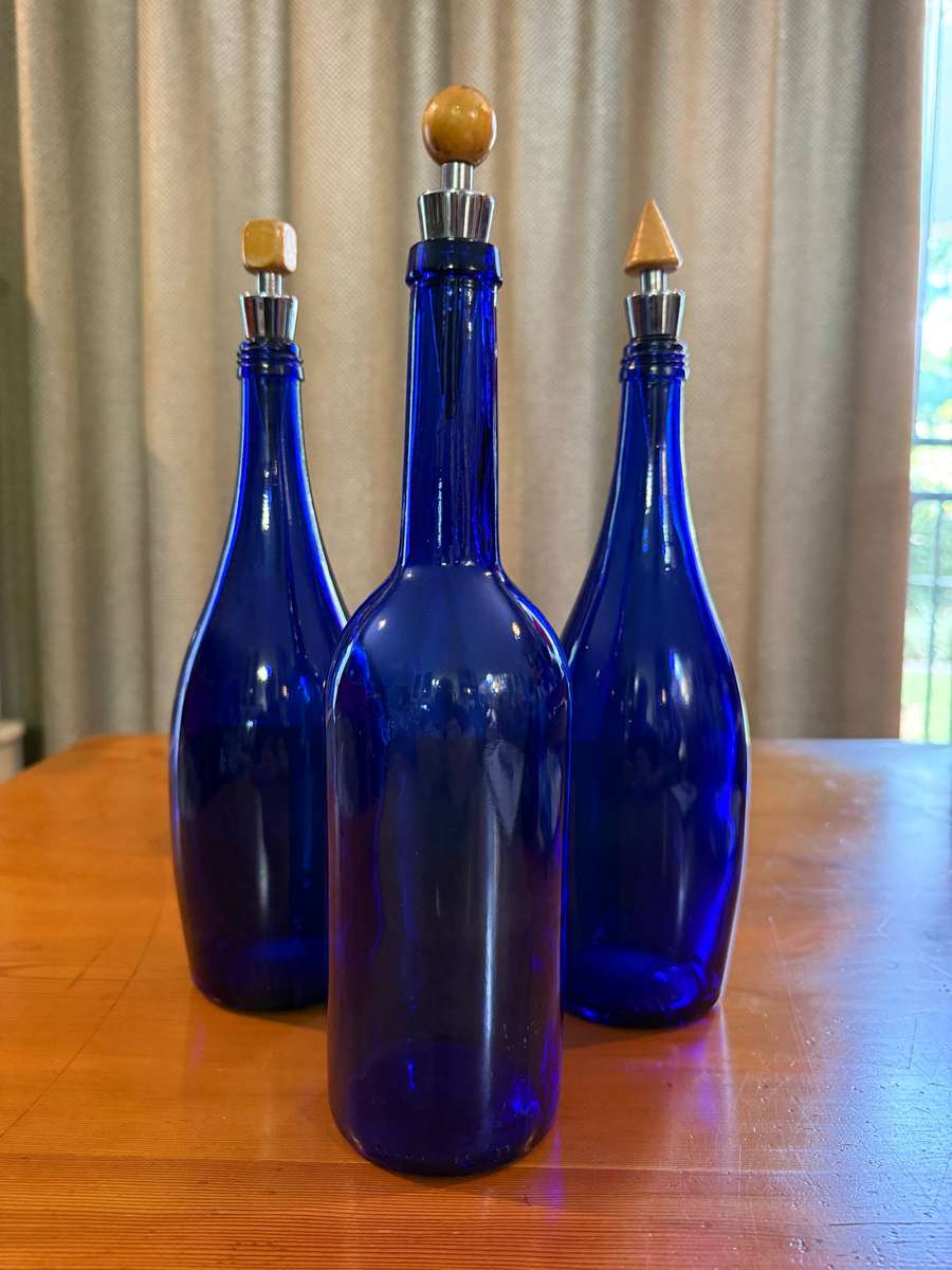 THREE BLUE BOTTLES
