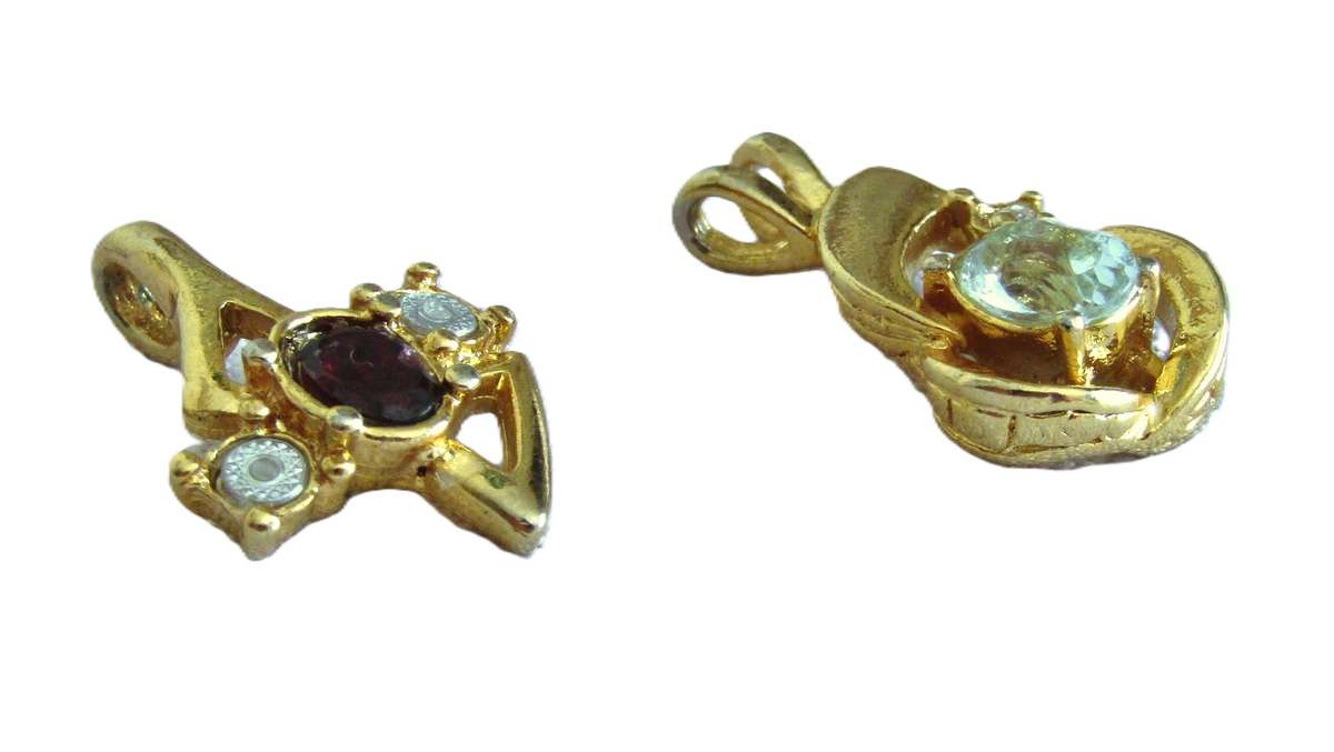 Pair of vintage gold tone 1970s style pendants with faceted crystal