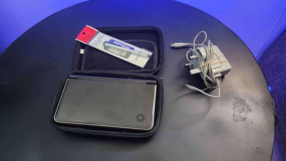 Nintendo DSi XL handheld console with accessories and pouch - Bronze