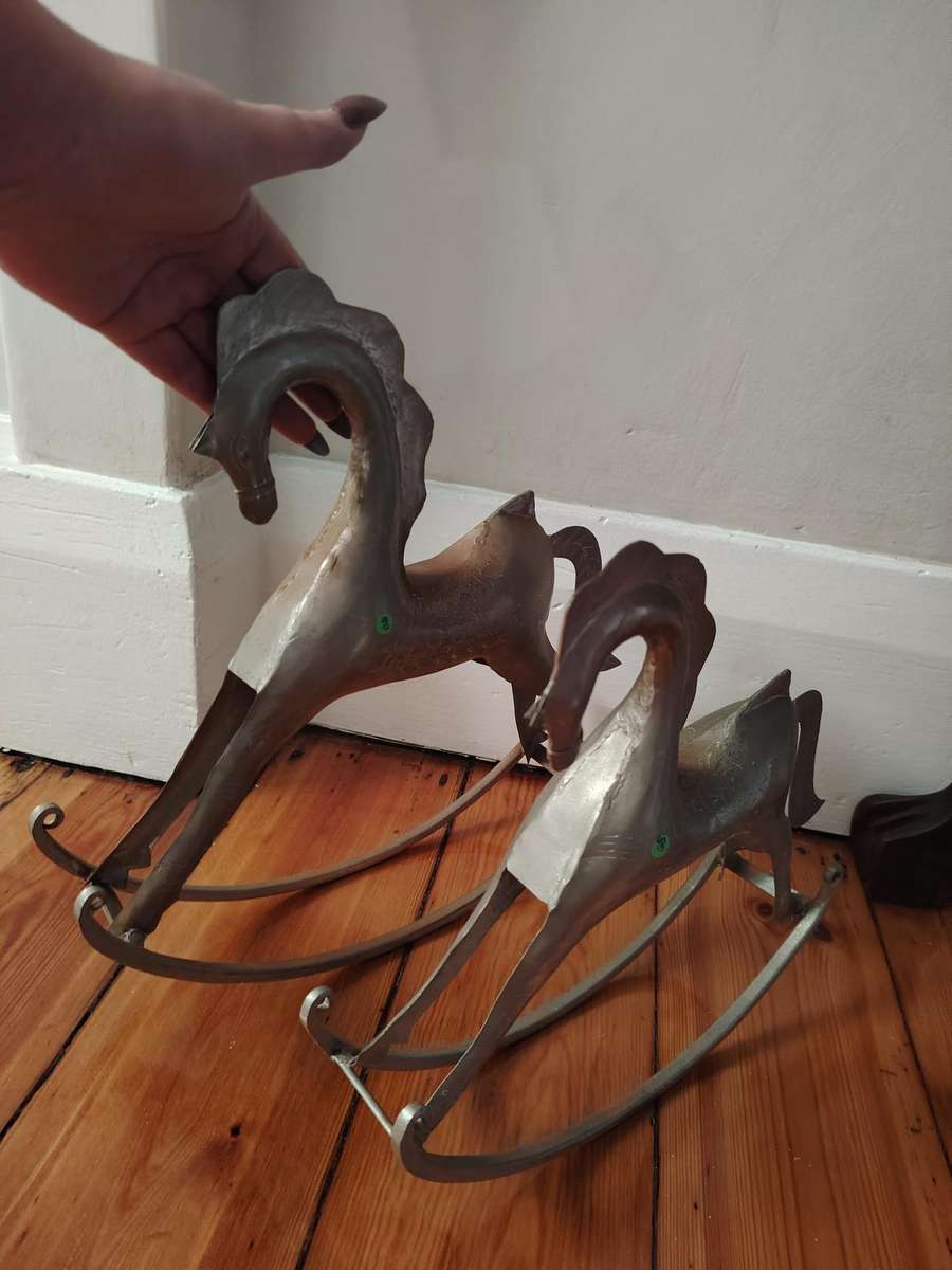 Two handcrafted metal rocking horse figurines