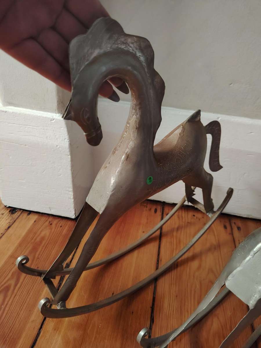 Two handcrafted metal rocking horse figurines