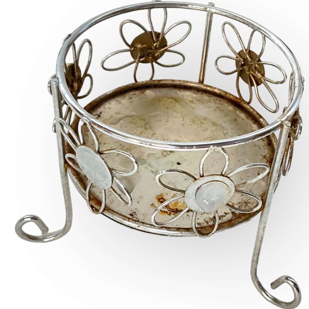 Three different styles of lighting- brass candlestick, Danish candleholder, modern floral tea light