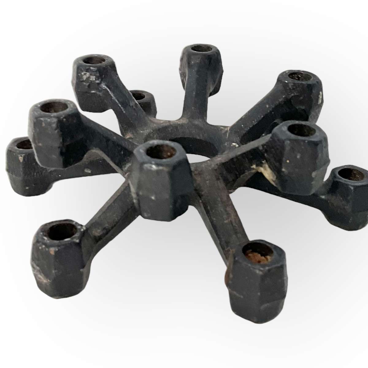 Three different styles of lighting- brass candlestick, Danish candleholder, modern floral tea light