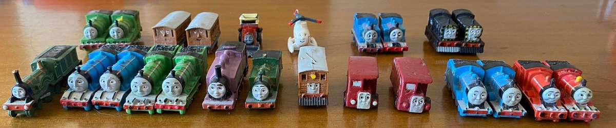 Miniature wind up and wooden Thomas and Friends trains with Thomas inspired storage containers