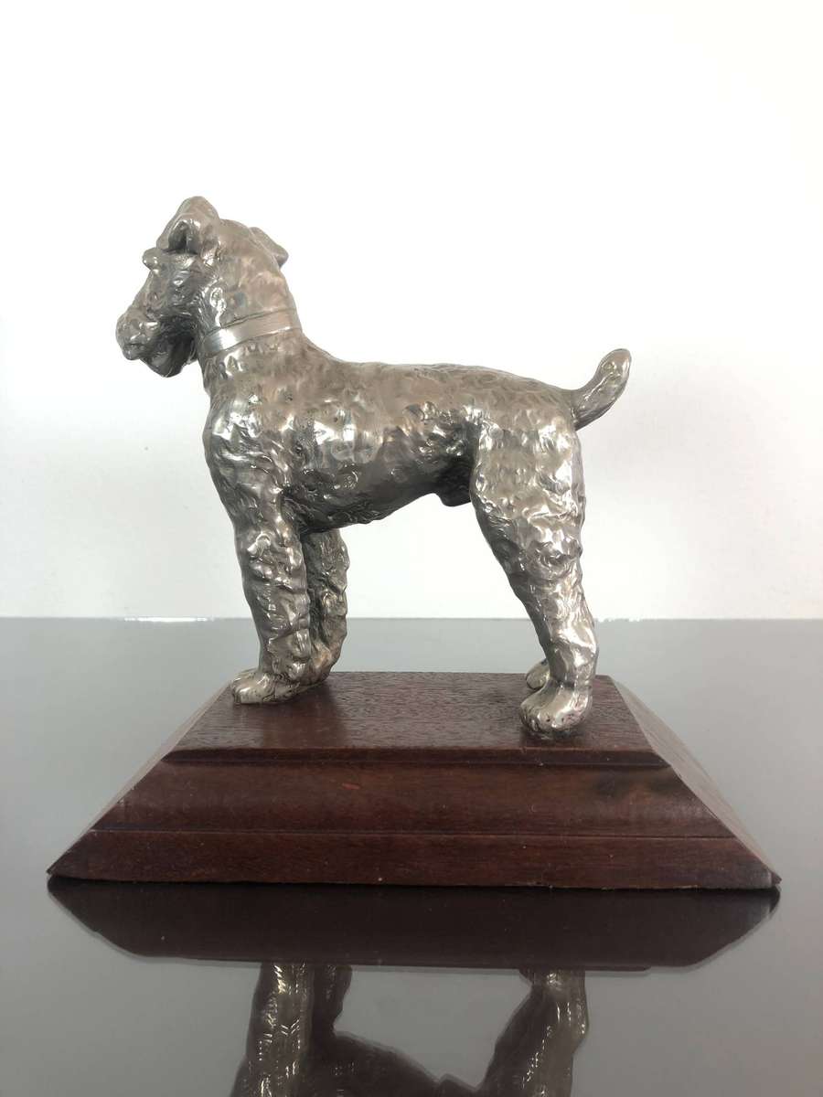 A Detailed Cast Sculpture Of A Wired Hair Fox Terrier On Stand