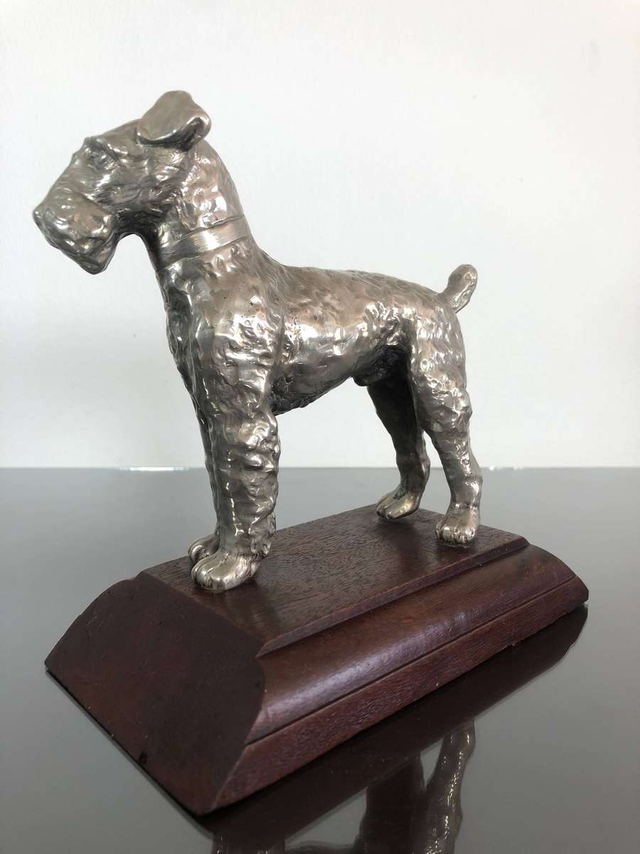 A Detailed Cast Sculpture Of A Wired Hair Fox Terrier On Stand