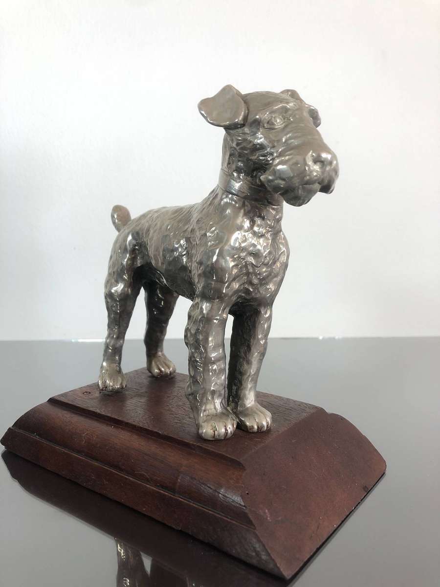 A Detailed Cast Sculpture Of A Wired Hair Fox Terrier On Stand