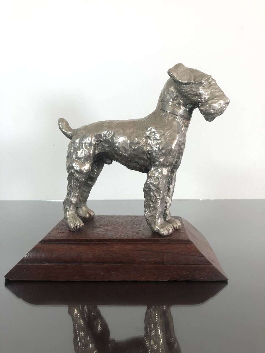 A Detailed Cast Sculpture Of A Wired Hair Fox Terrier On Stand