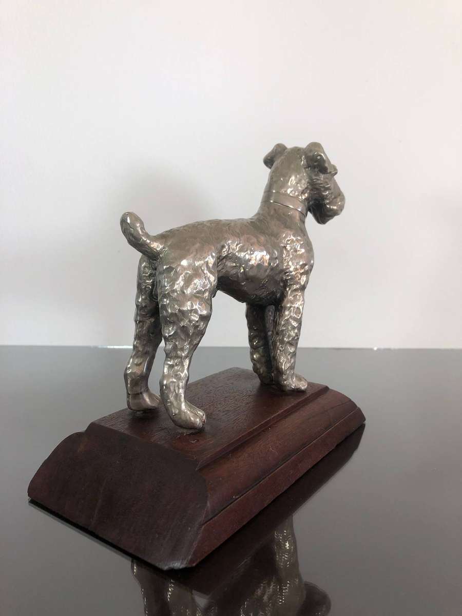A Detailed Cast Sculpture Of A Wired Hair Fox Terrier On Stand