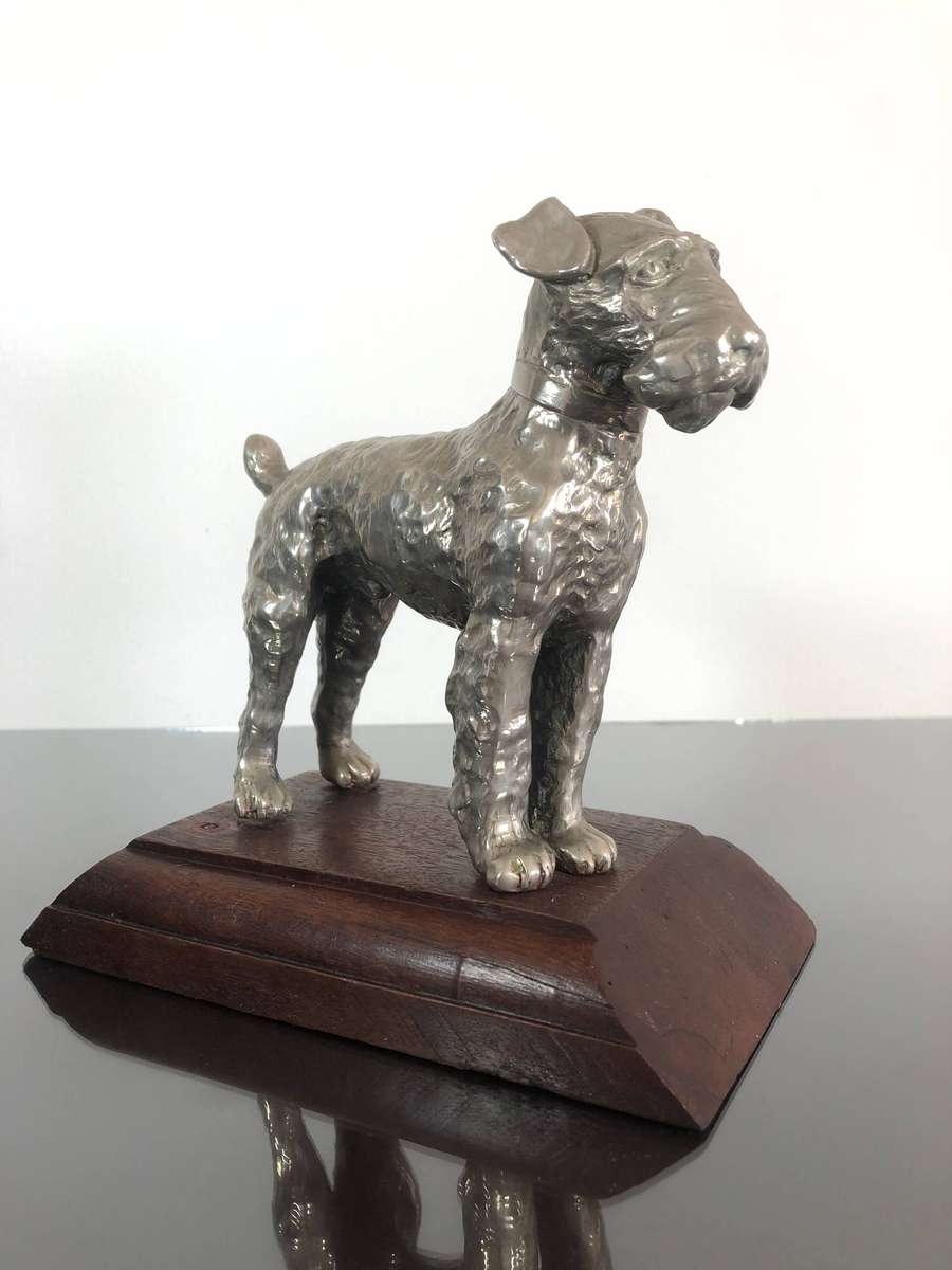 A Detailed Cast Sculpture Of A Wired Hair Fox Terrier On Stand