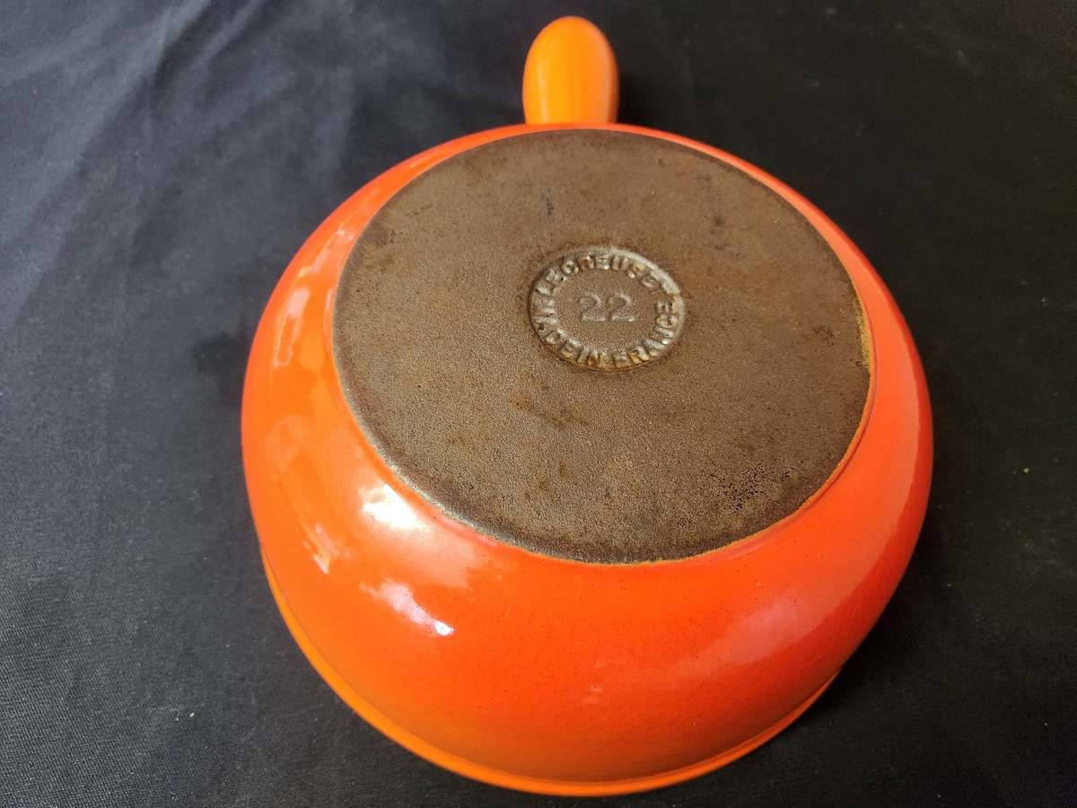 TWO VINTAGE LE CREUSET PAN-HANDLED POTS, NOS 18 AND 22