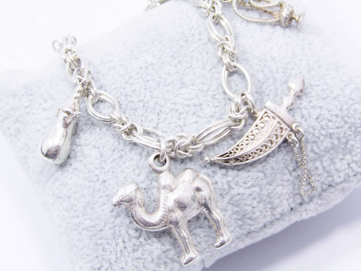 A Lovely Weighty Bracelet With Charms in Sterling Silver.