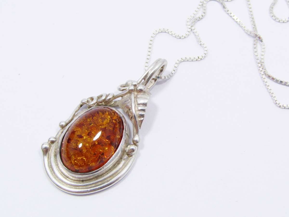 A Beautiful Detailed Amber Pendant on Chain in Sterling Silver