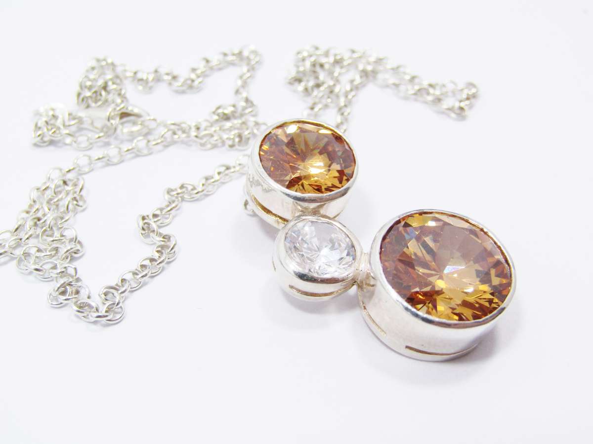 A Beautiful Orange And Clear Zirconia Pendant On Chain in Sterling Silver.