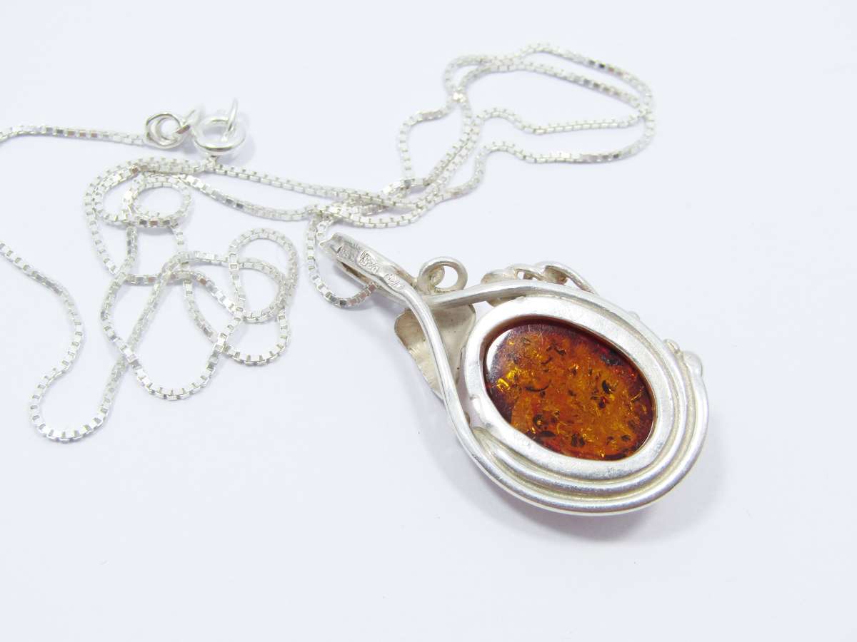 A Beautiful Detailed Amber Pendant on Chain in Sterling Silver