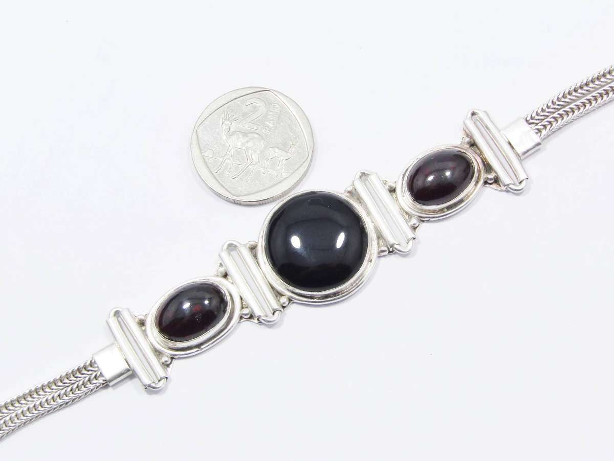 A Gorgeous Weighty Cabochon Garnet and Onyx Gemstone Bracelet in Sterling Silver.