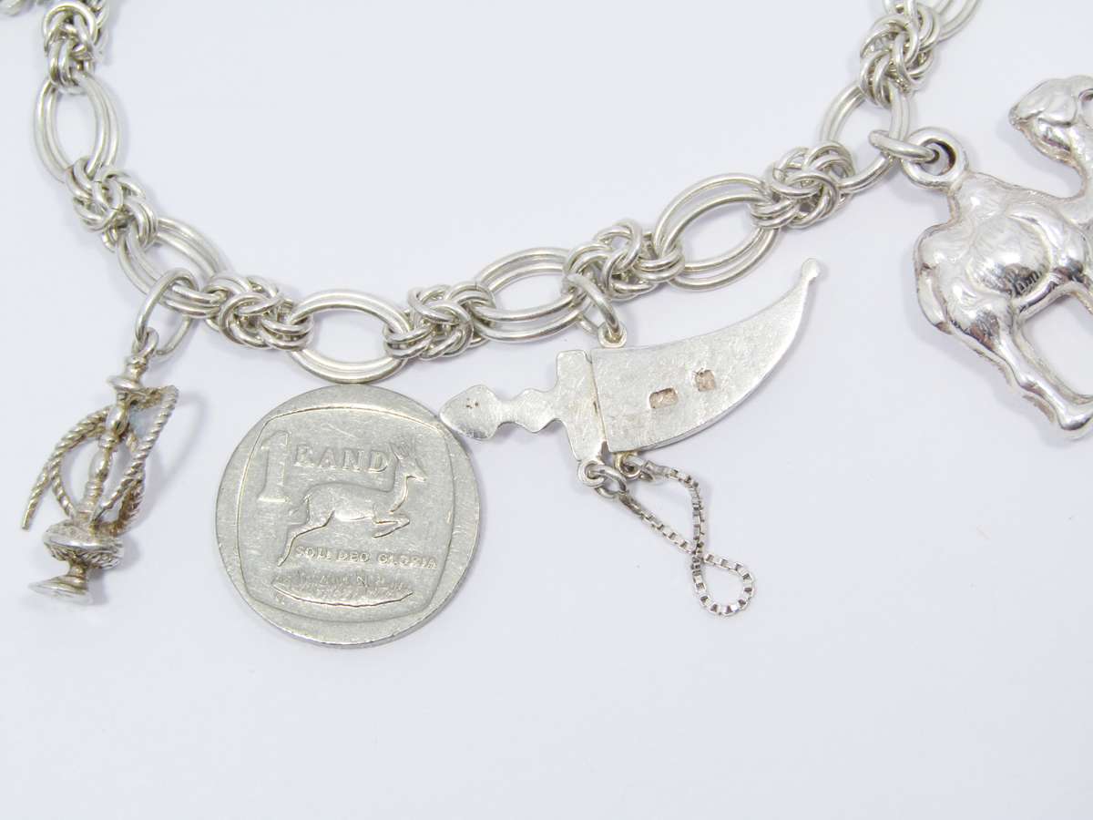 A Lovely Weighty Bracelet With Charms in Sterling Silver.