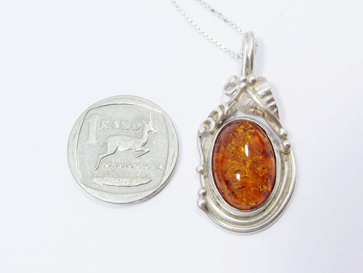 A Beautiful Detailed Amber Pendant on Chain in Sterling Silver