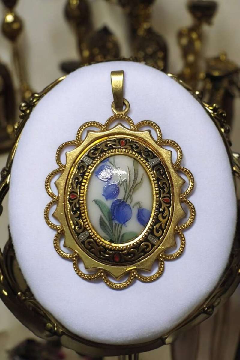 Forget me not pendant with a gold tone