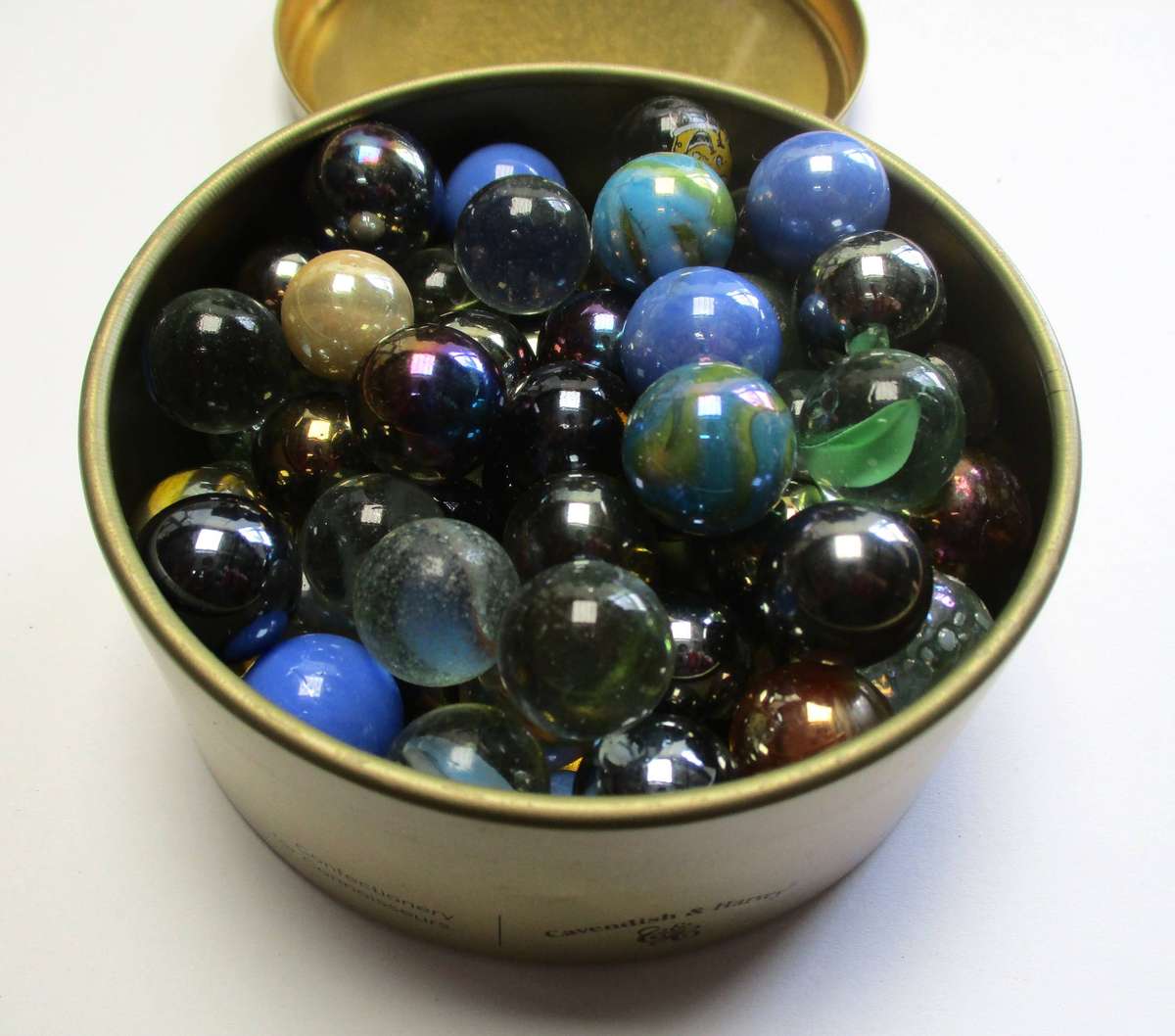 Glass Marbles in small tin.