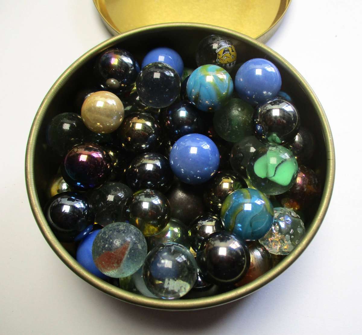 Glass Marbles in small tin.
