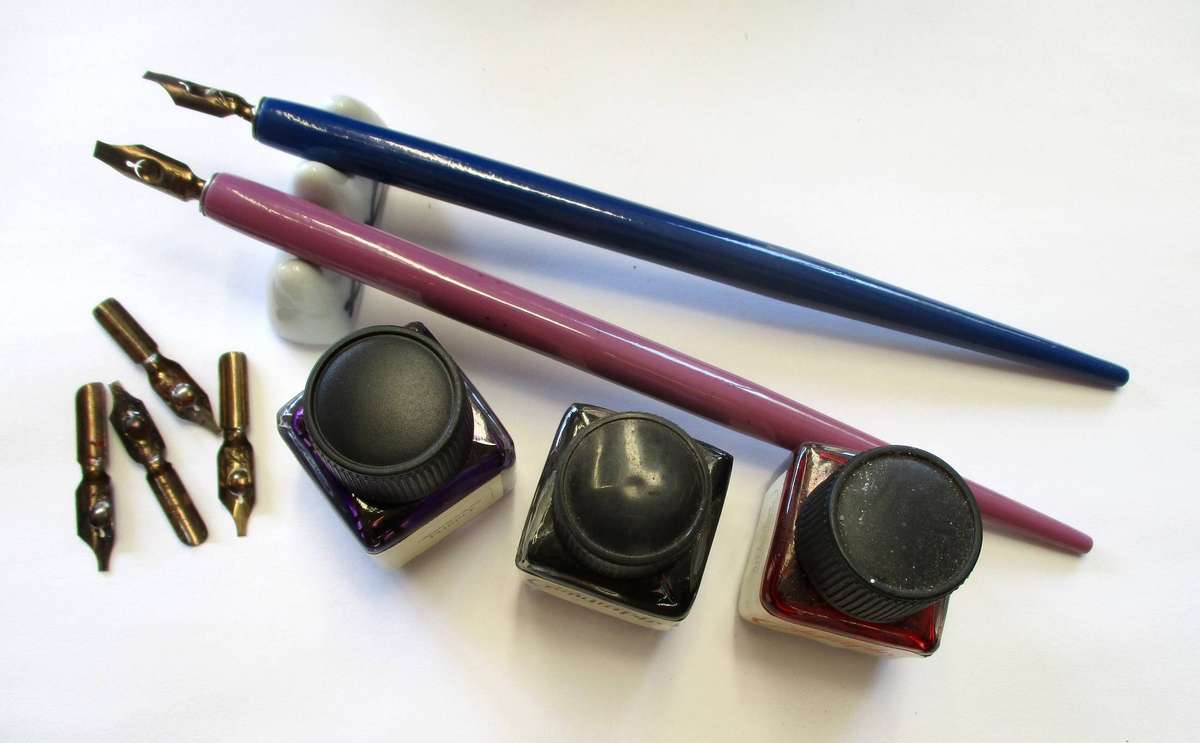 Calligraphy items - two pens and nibs, small inks and stand included.