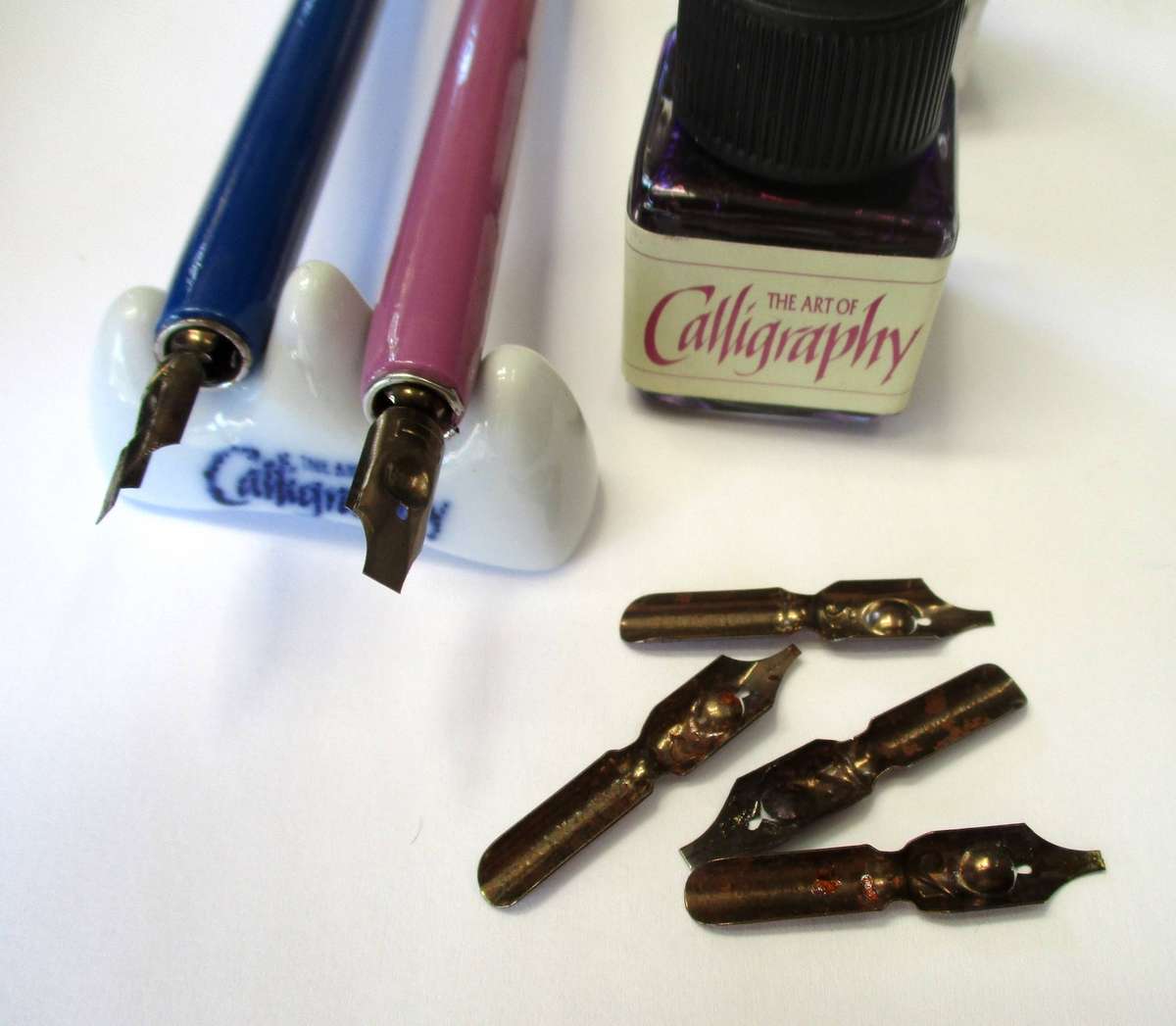 Calligraphy items - two pens and nibs, small inks and stand included.