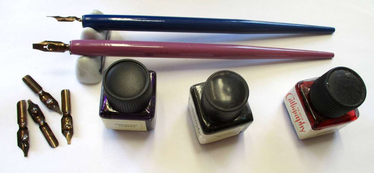 Calligraphy items - two pens and nibs, small inks and stand included.