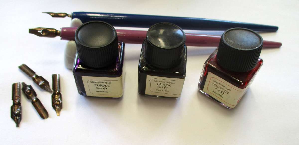 Calligraphy items - two pens and nibs, small inks and stand included.