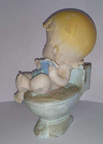 Boy on toilet figurine