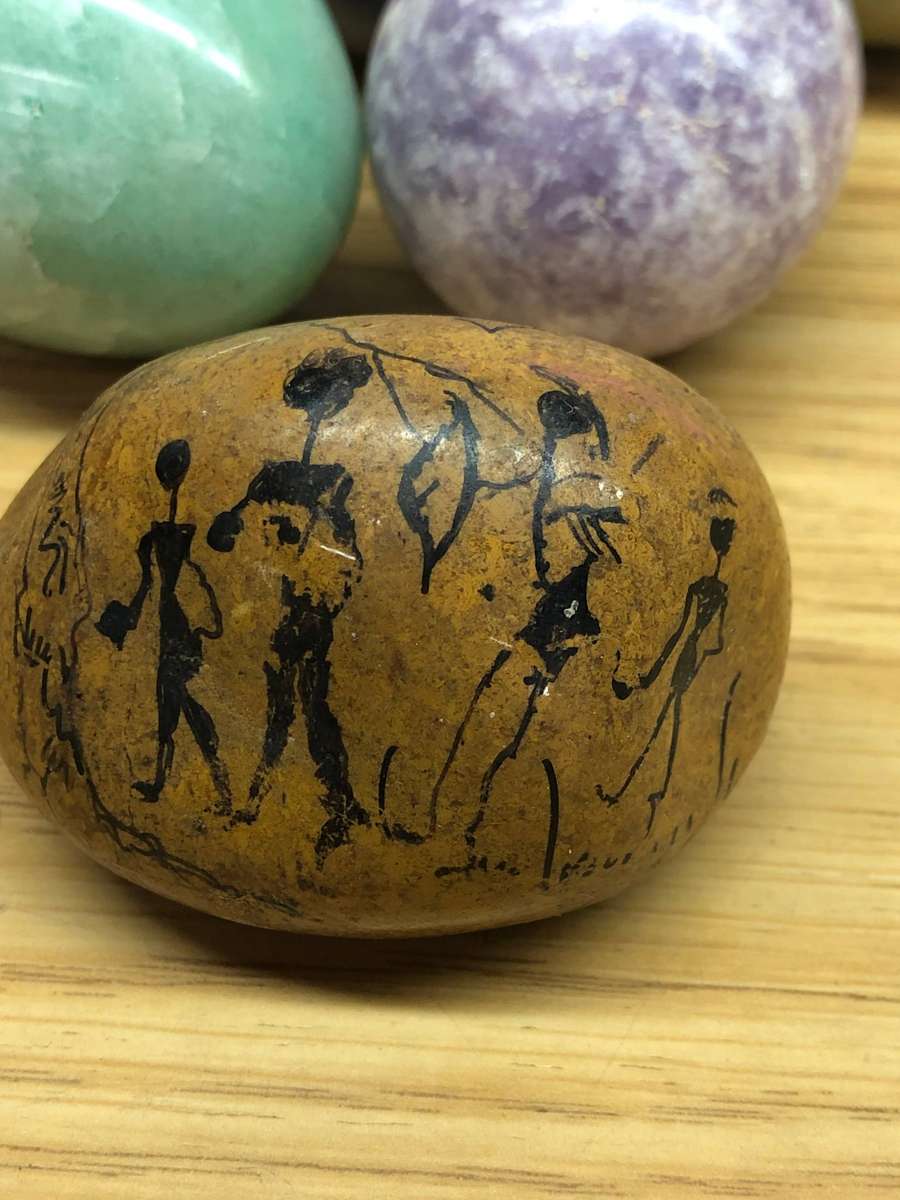 Collection of precious stone eggs and a bushmen painted rock